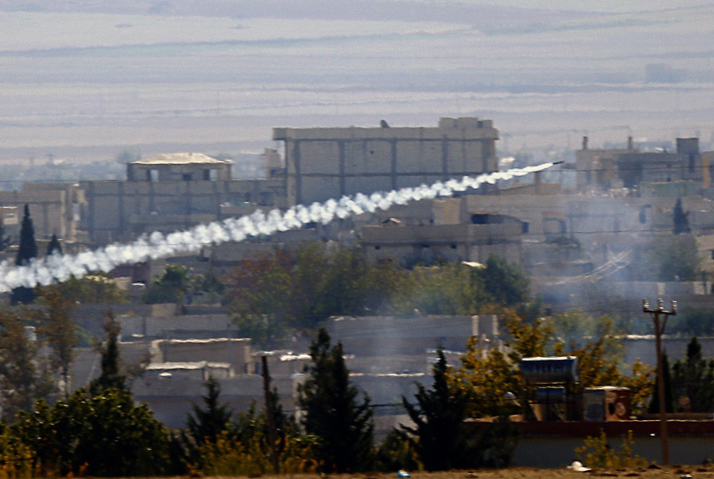 A rocket fired by Isis forces flies from the east to the west side of the Syrian town of Kobani during fighting on 6 November 2014