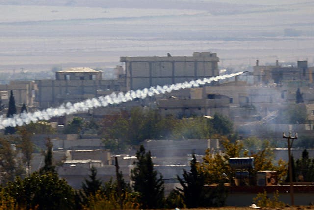 A rocket fired by Isis forces flies from the east to the west side of the Syrian town of Kobani during fighting on 6 November 2014