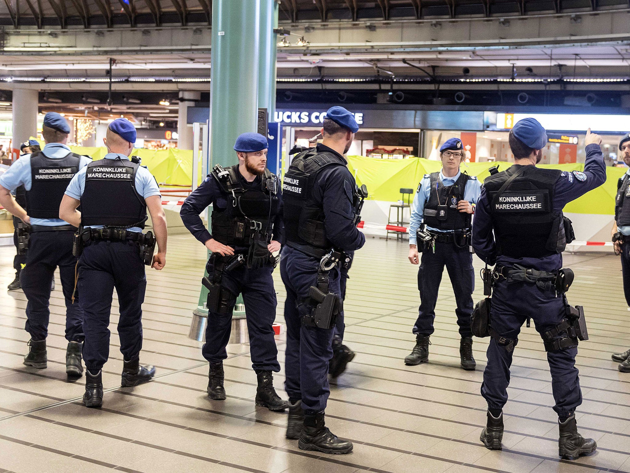 Amsterdam's international airport was evacuated after police shot a suspect who was allegedly threatening passengers with a knife