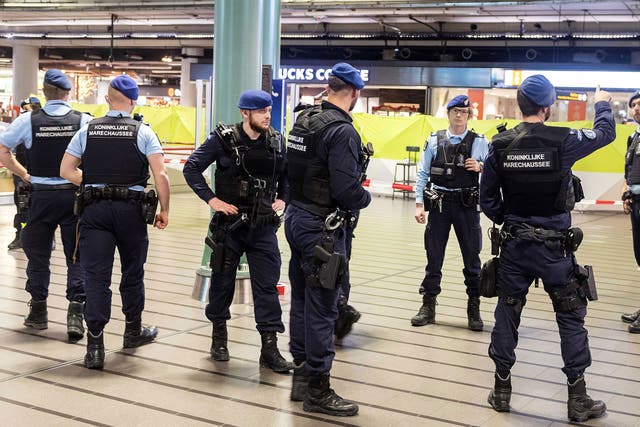 Amsterdam's international airport was evacuated after police shot a suspect who was allegedly threatening passengers with a knife