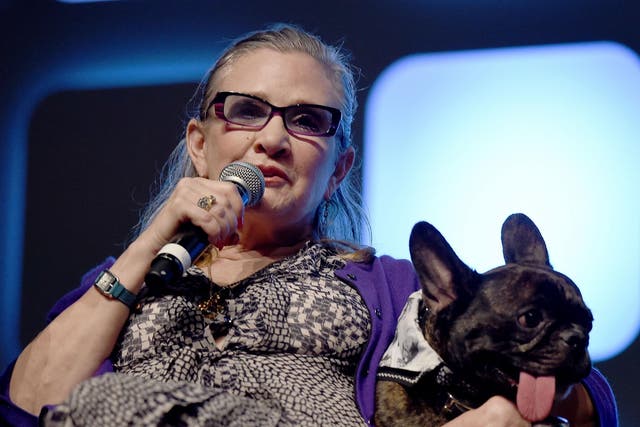 Carrie Fisher and dog Gary on stage during Future Directors Panel at the Star Wars Celebration 2016 at ExCel on July 17, 2016 in London, England. Credit: Ben A. Pruchnie/Getty Images for Walt Disney Studios.