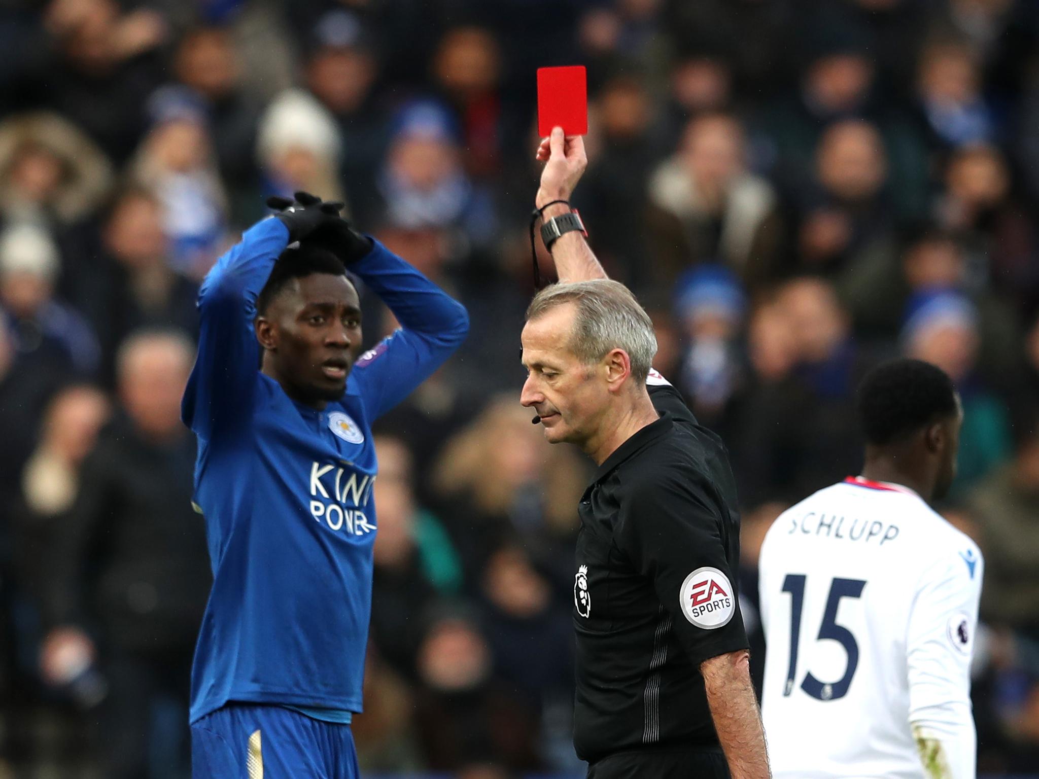 Wilfred Ndidi is sent-off by referee Martin Atkinson after a second booking for diving