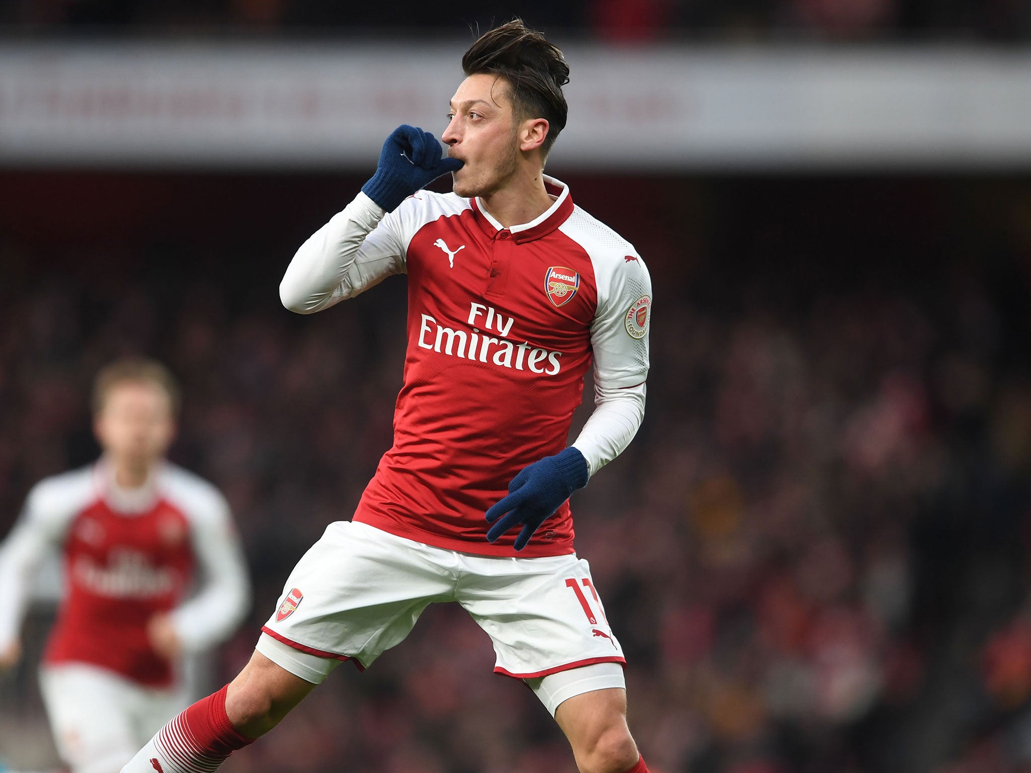 Mesut Ozil celebrates his sublime first-half volley for Arsenal