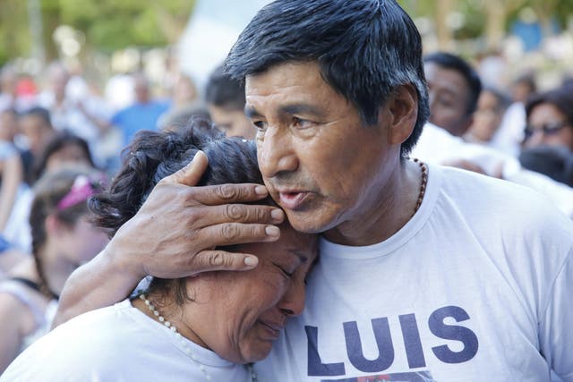 A man embraces a woman during a march organized by families of the 44 crew members of the submarine ARA San Juan