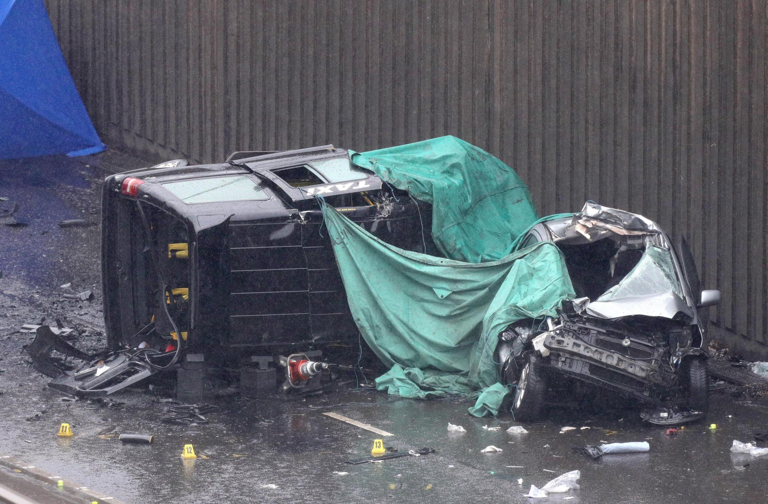 A black cab left on its side following the crash which killed its driver and two passengers