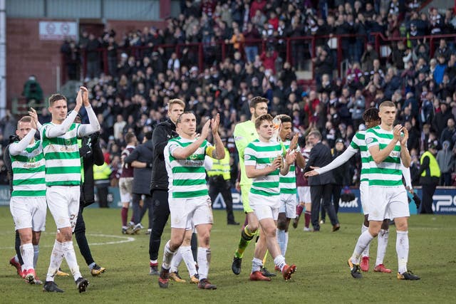 Celtic players applaud the visiting supporters