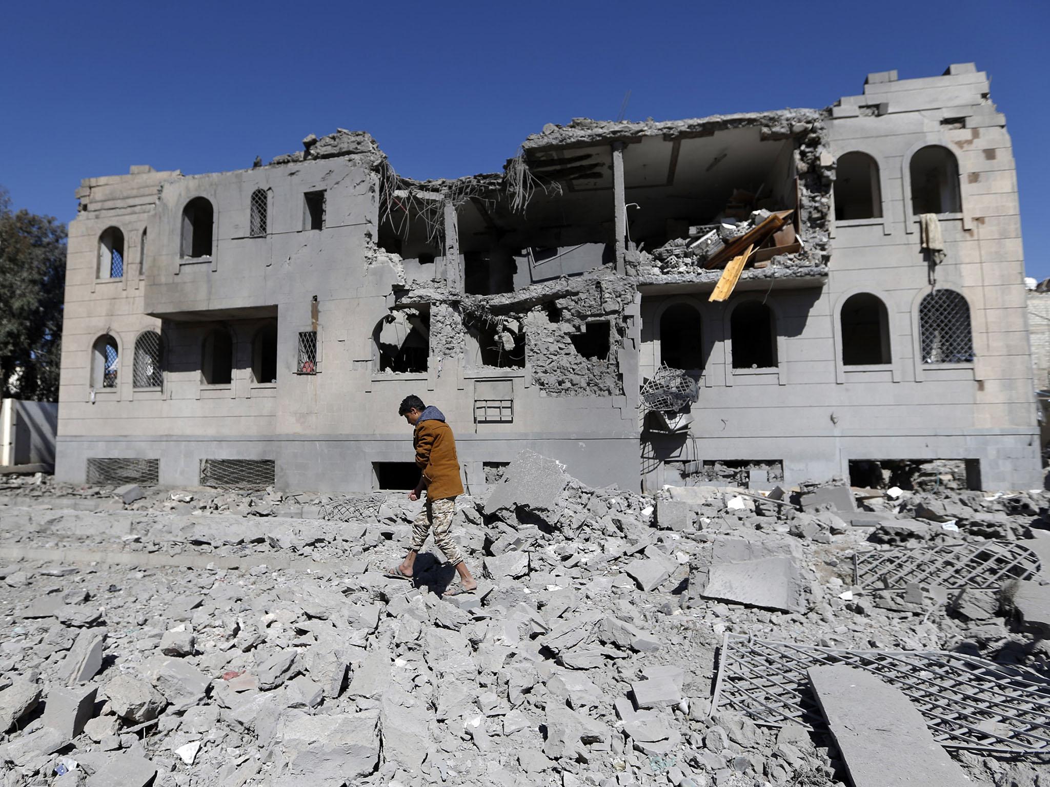 Residents pick over the wreckage of a bombed home in Sanaa, Yemen’s biggest city