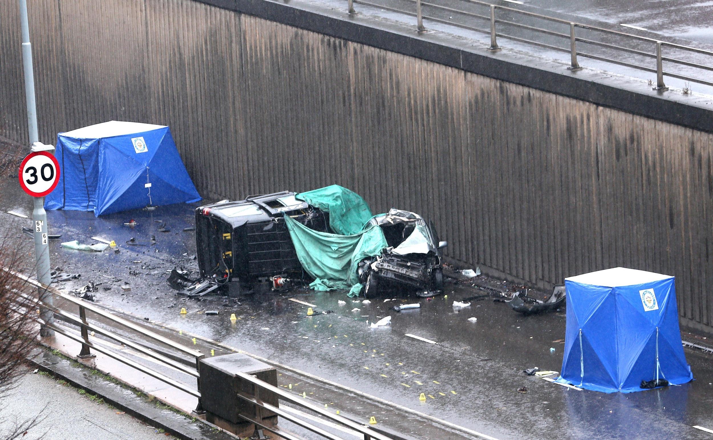 A black taxi is left on its side following the crash on Lee Bank Middleway, which killed its driver and two passengers