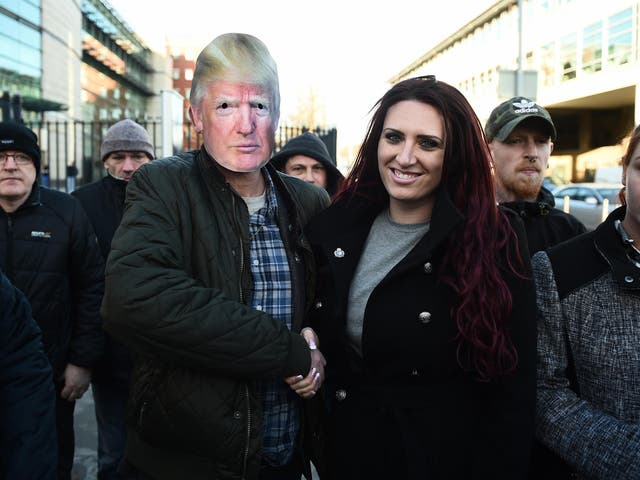 Britain First deputy leader Jayda Fransen is congratulated by a supporter wearing a Donald Trump mask