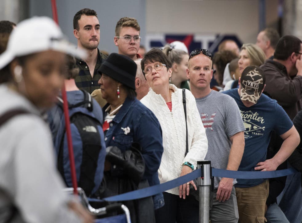 People wait in line to rebook flights at Hartfield-Jackson Atlanta International Airport