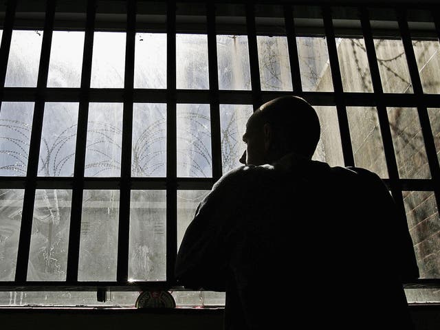 19 year old inmate James looks out of the window of the Young Offenders Institution attached to Norwich Prison on August 25, 2005 in Norwich, England.