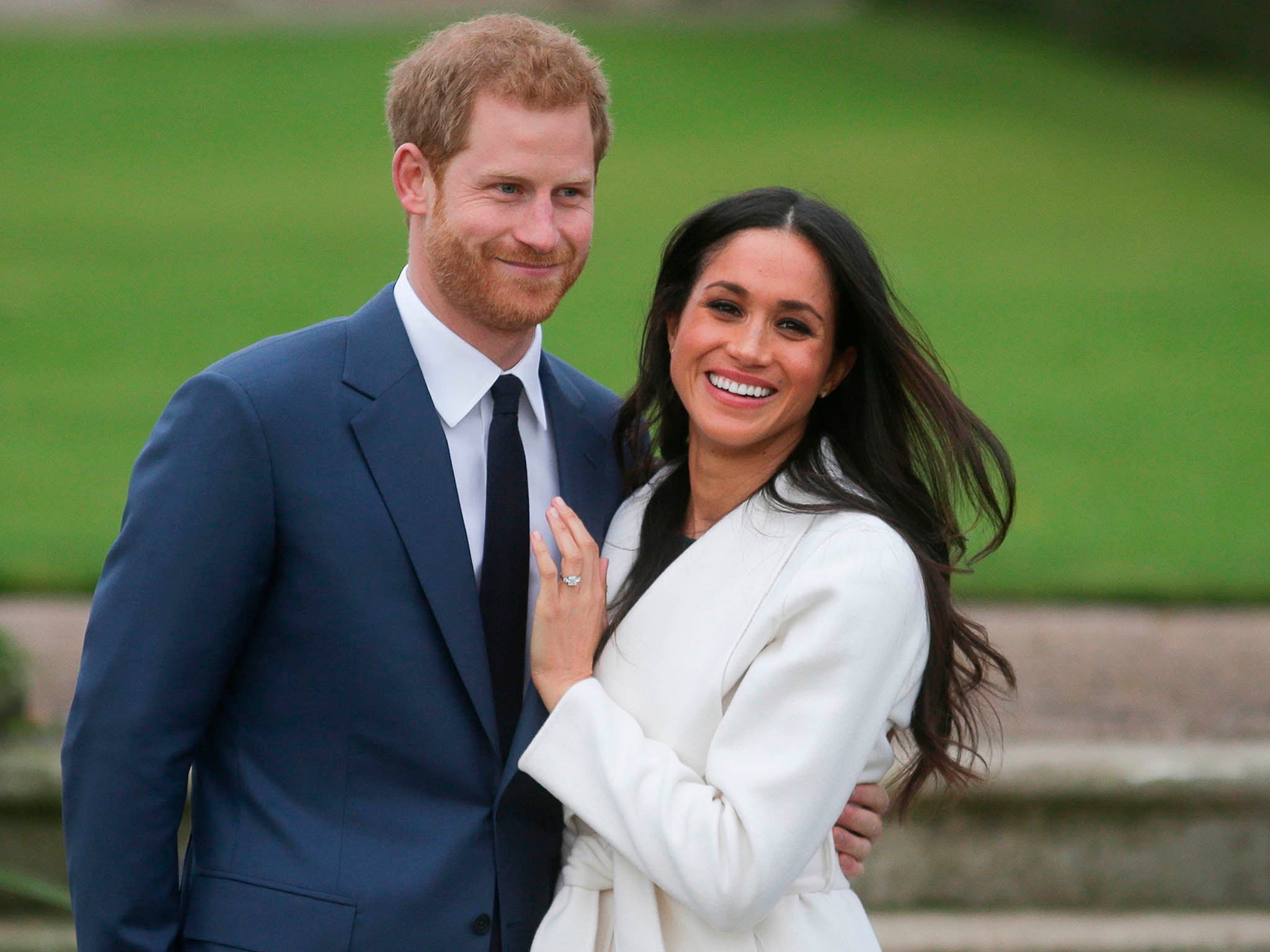 Prince Harry and his fiancée Meghan Markle pose at Kensington Palace following the announcement of their engagement