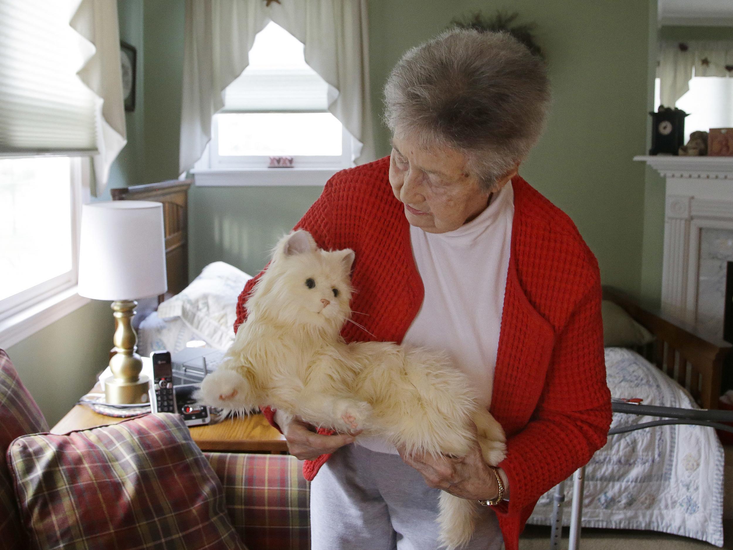 93-year-old Mary Derr holds her robot cat 'Buddy'