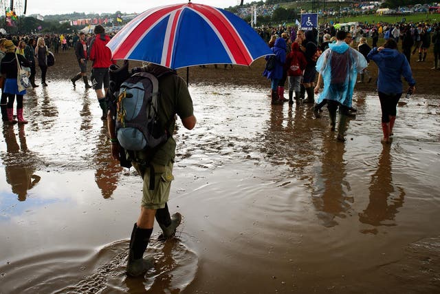 Festival goers brace heavy rain at the Glastonbury Festival
