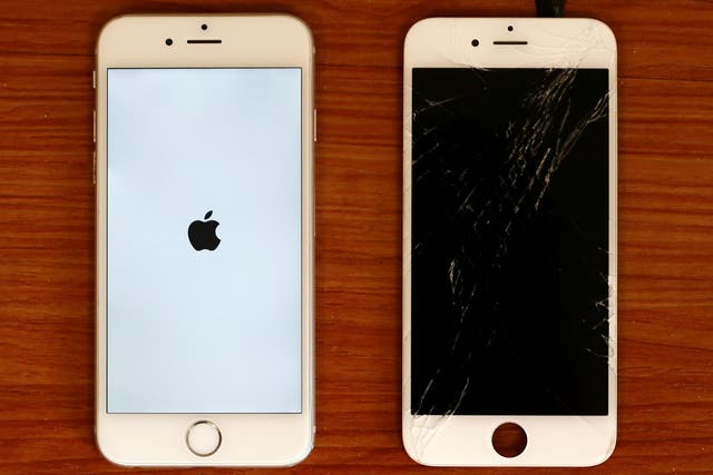 A destroyed iPhone screen and a fixed mobile phone, iPhone 6 by Apple, are pictured in a shop in Fuerstenfeldbruck near Munich, Germany August 16, 2016