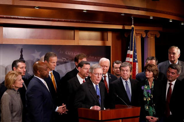 Senate Majority Leader Mitch McConnell, accompanied by members of the Republican Conference, speaks at a news conference about the passage of the Tax Cuts and Jobs Acts at the US Capitol in Washington