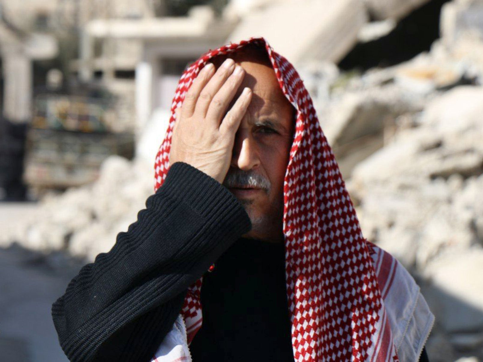 &#13;
A man in eastern Ghouta covers his right eye in solidarity with Karim (AP/Ghouta Media Centre)&#13;