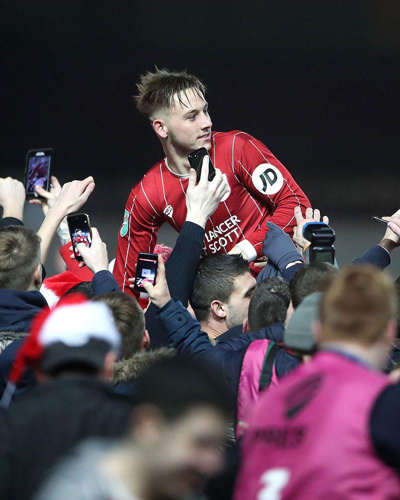 Josh Brownhill celebrates with fans after victory