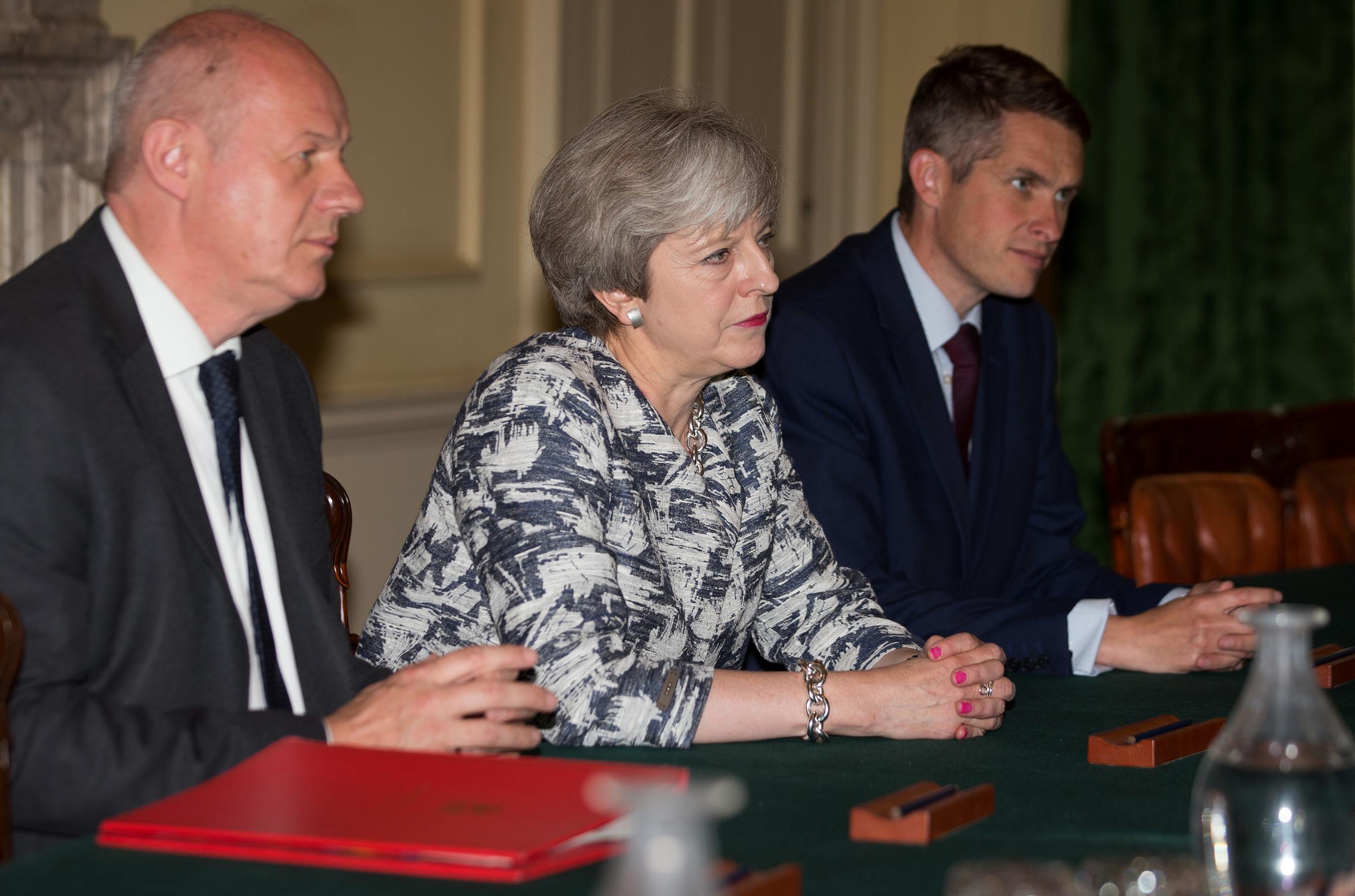 Damian Green at Theresa May's side (left) as she secures a deal to hold power with the Northern Irish DUP