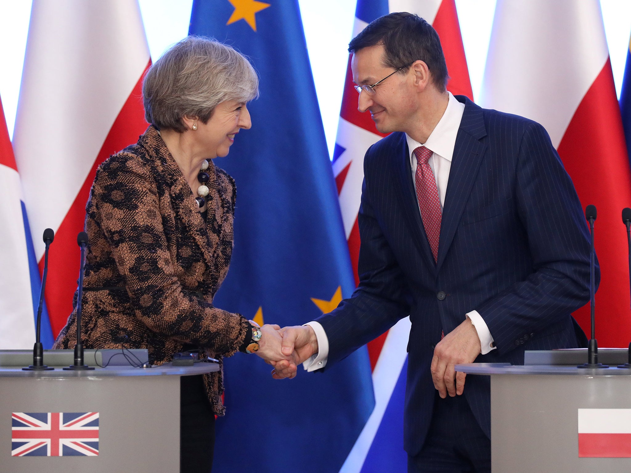 Poland’s prime minister Mateusz Morawiecki and Theresa May shake hands