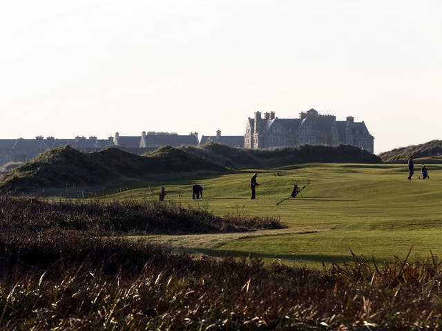 Golfers play on the fairway towards the clubhouse at Trump International Golf Course, Doonbeg