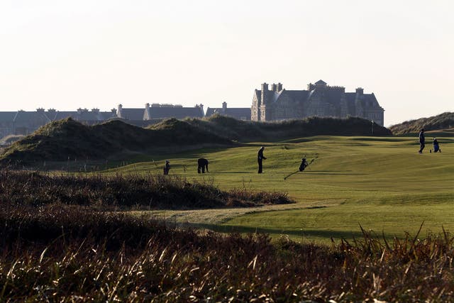 Golfers play on the fairway towards the clubhouse at Trump International Golf Course, Doonbeg