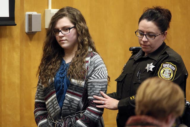 Anissa Weier, one of two Wisconsin girls who tried to kill a classmate to win favour with a fictional horror character named Slender Man, is led into the Waukesha County Court for her sentencing hearing