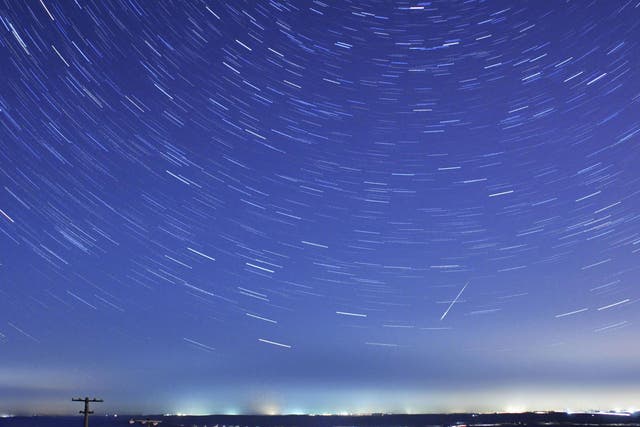 A meteor streaks past stars during the Quadrantids meteor shower in Qingdao on the east coast of China