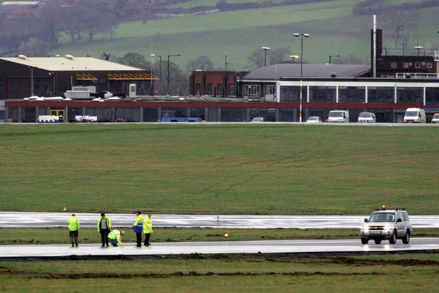 Airport staff inspect the runway at Bristol airport in January 2006