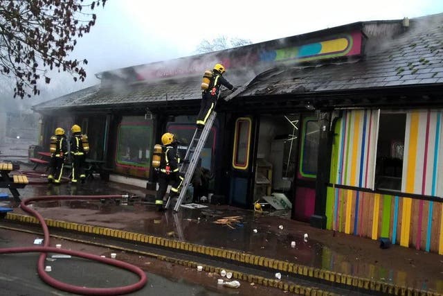 Fire crews tackle a blaze at a cafe and shop at London zoo