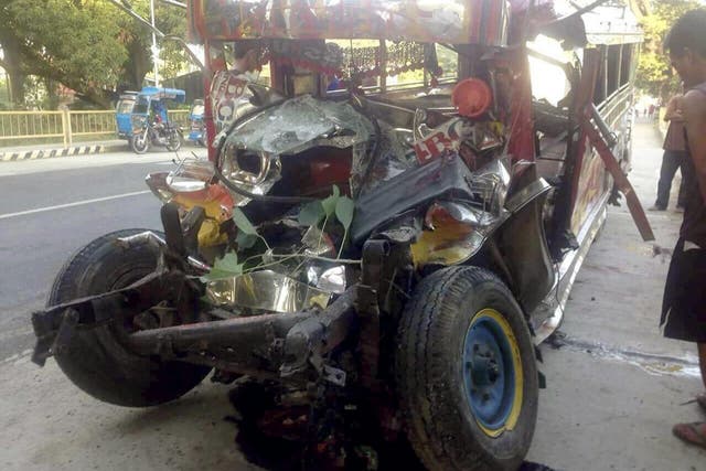 The wreckage of a passenger van in La Union province