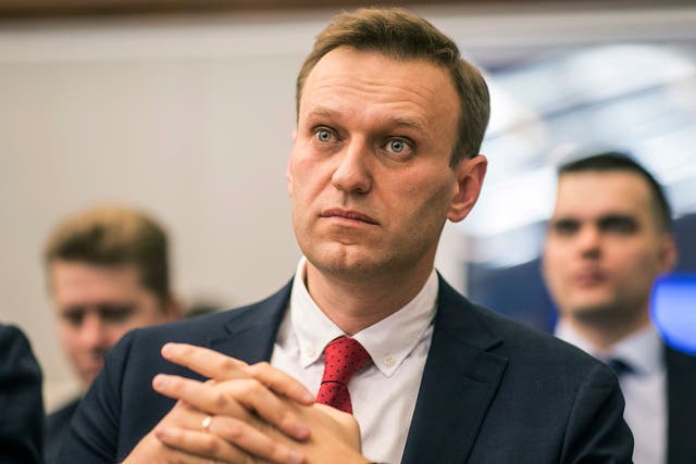 Opposition leader Alexei Navalny sits at Russia's Central Election Commission, which banned him from running for president