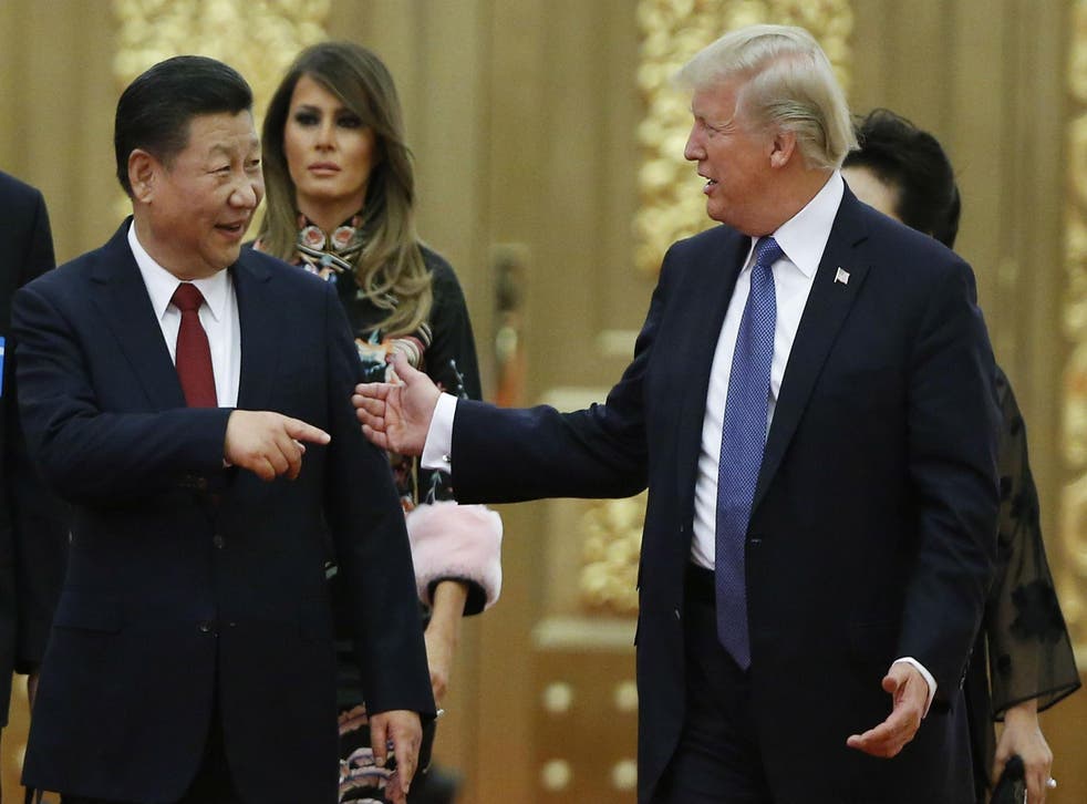 President Trump and China's premier Mr Xi arrive at a state dinner at the Great Hall of the People on 9 November in Beijing