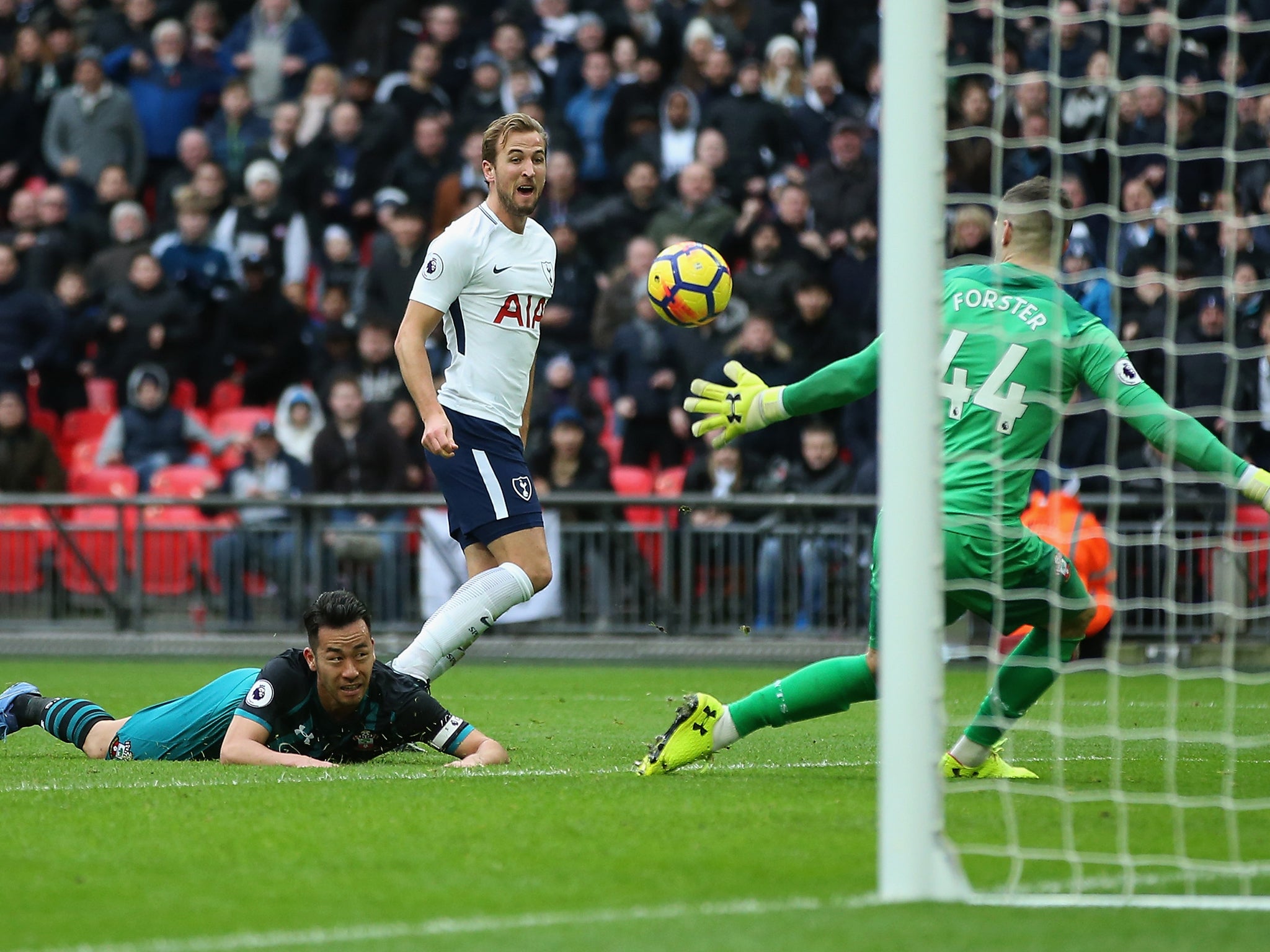 Kane chips the ball past Fraser Forster to complete his hat-trick
