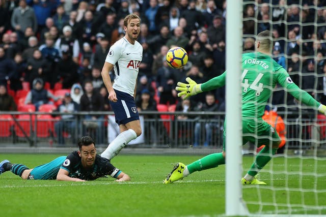 Kane chips the ball past Fraser Forster to complete his hat-trick