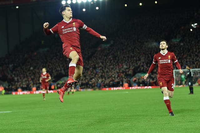 Philippe Coutinho celebrates putting Liverpool ahead of Swansea