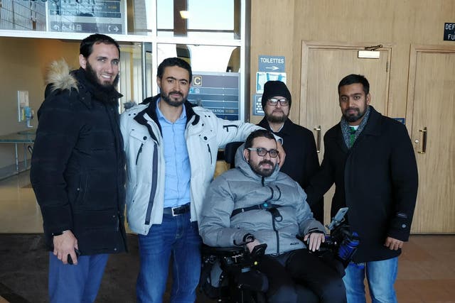 Aymen Derbali (centre) has lost the use of his legs after being shot seven times