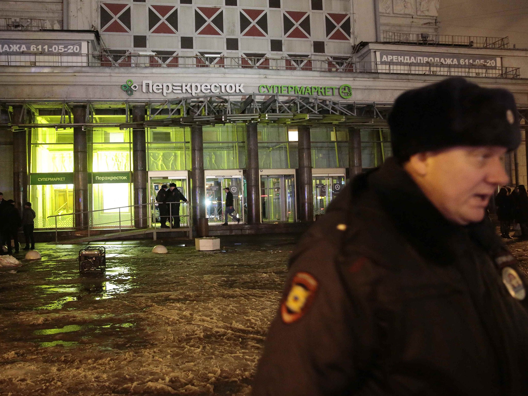 A policeman stands guard near a supermarket after an explosion in St Petersburg, Russia on 27 December, 2017