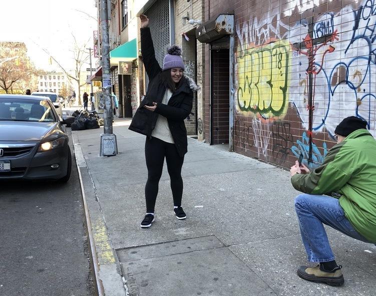 New Yorkers pose with the giant phallic painting