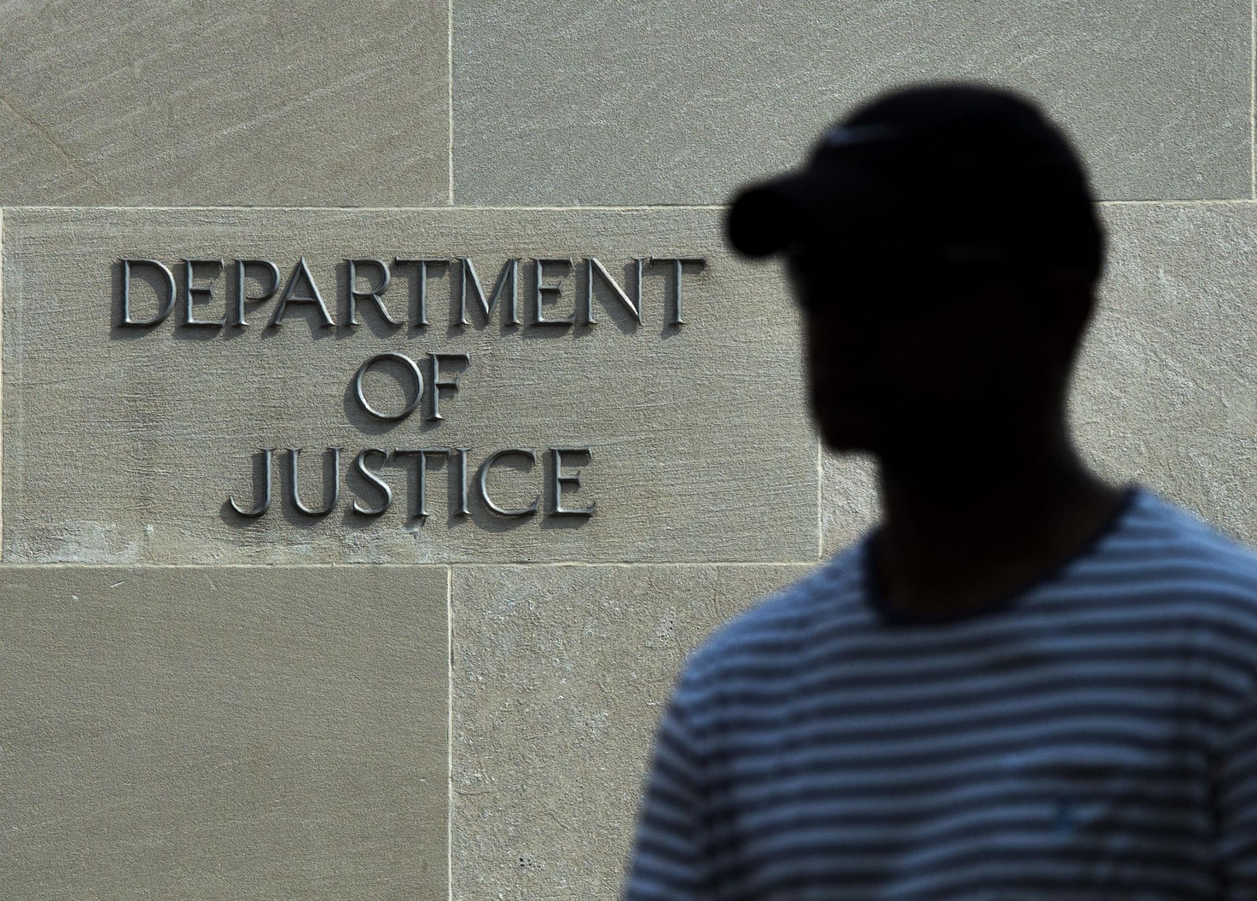A man walks past the Department of Justice in Washington, DC