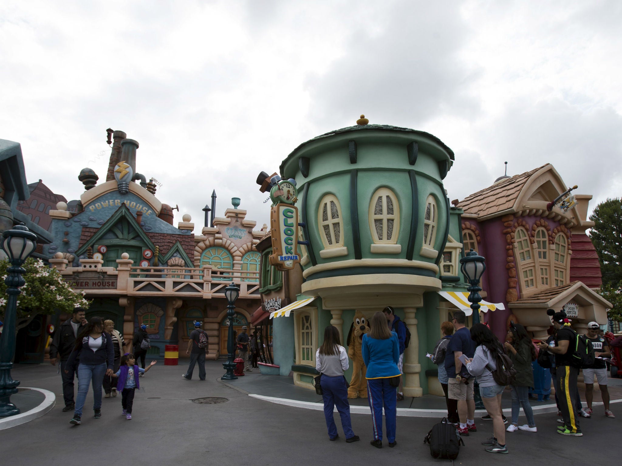 People walk through Mickey's Toontown, one of the areas affected by a power outage at Disneyland
