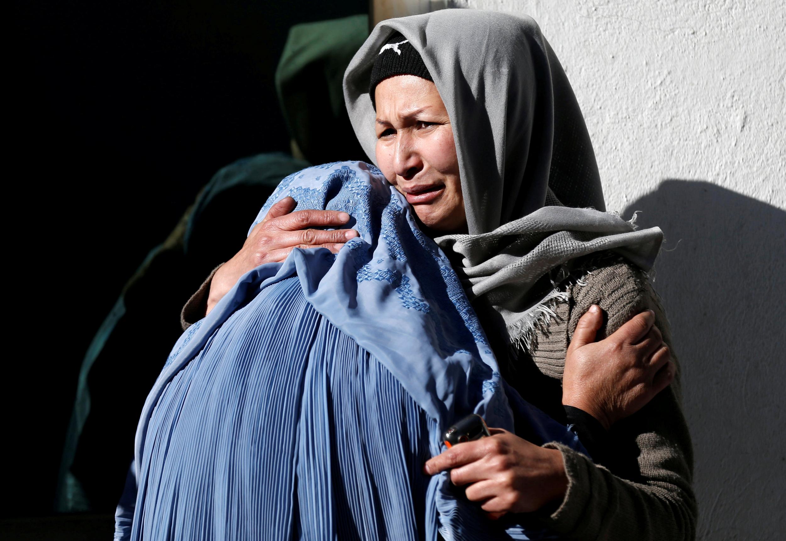 Afghan women mourn inside a hospital compound after a suicide attack in Kabul