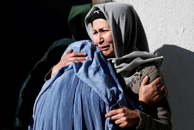 Afghan women mourn inside a hospital compound after a suicide attack in Kabul