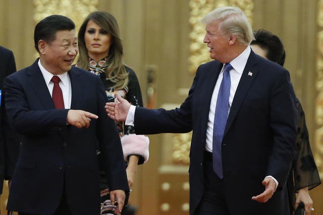 Donald Trump and Xi Jinping arrive at a state dinner at the Great Hall of the People in Beijing