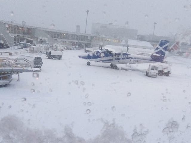 EasyJet passenger and Twitter user 'charliebrown' said he had been sat waiting on the runway at Glasgow Airport for an hour, and took this picture of the snow on the ground