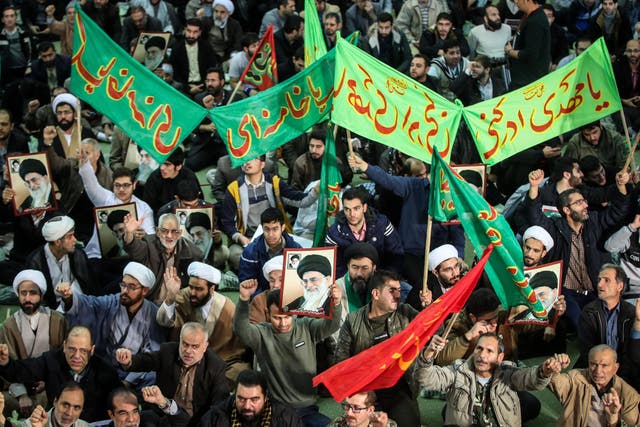 Iranians chant slogans as they march in support of the government in the capital Tehran on 30 December 2017
