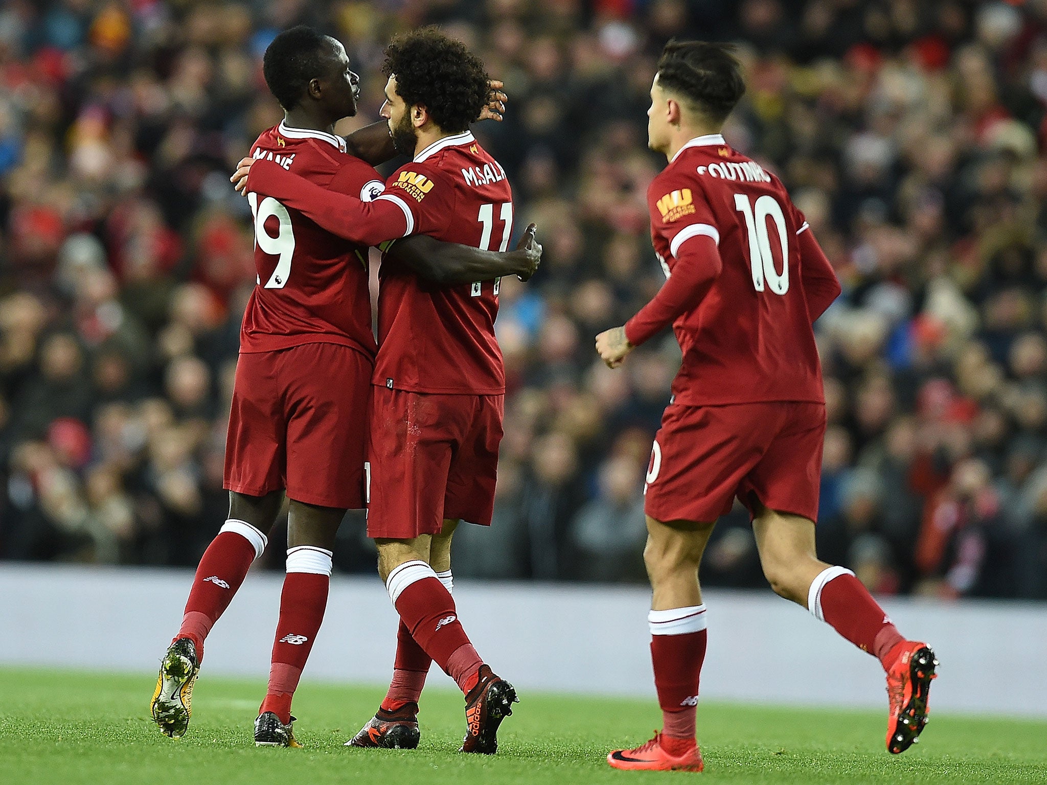 Mohamed Salah celebrates with teammates after hitting home the equaliser