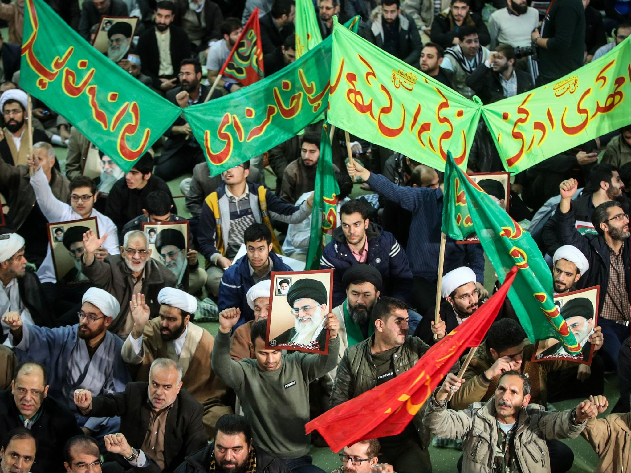 Iranians chant slogans as they march in support of the government near the Imam Khomeini grand mosque in the capital Tehran on 30 December 2017