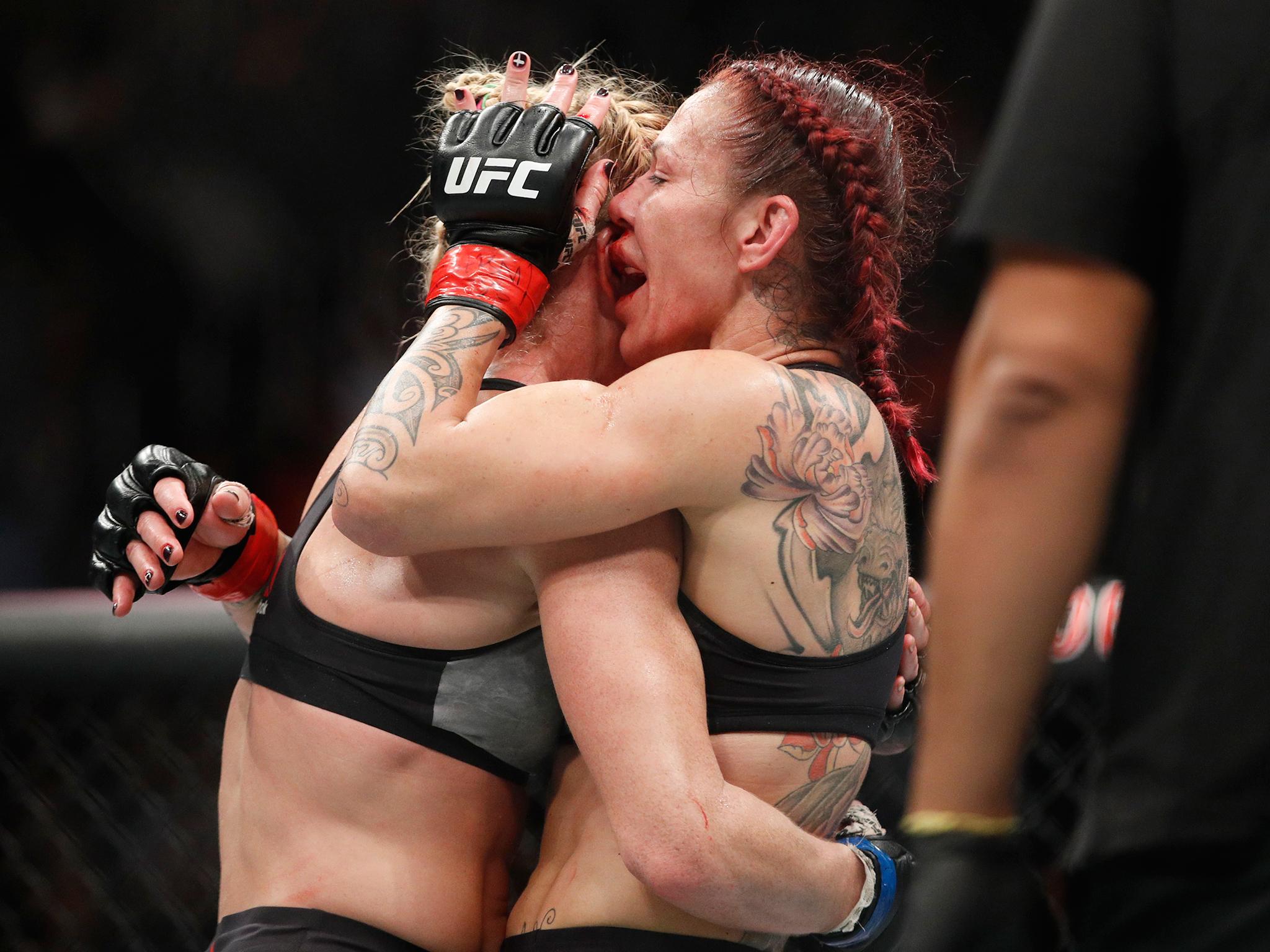 Holm and Cyborg embrace after the final hooter