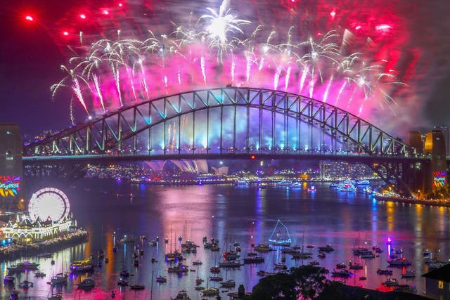Fireworks explode from the Sydney Harbour Bridge and the Sydney Opera House during the midnight display